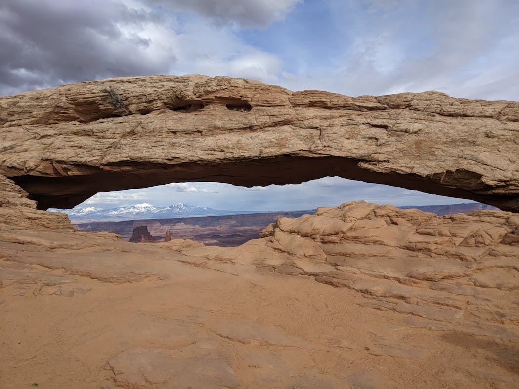 Mesa arch gives a keyhole view in Canyonlands National Park.