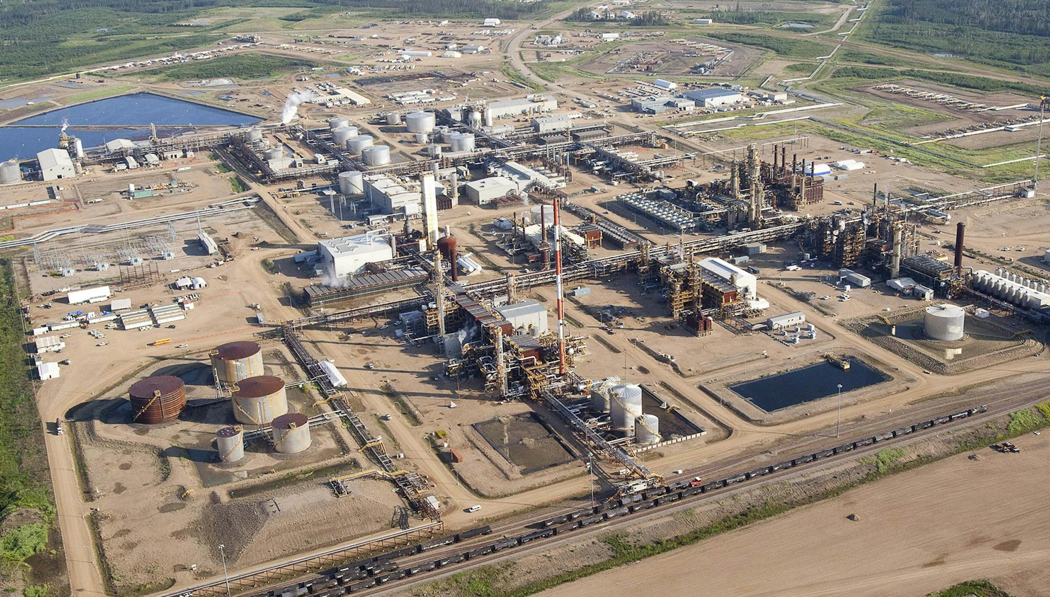 In this photo taken Tuesday, July 10, 2012, a Nexen oil sands facility seen from a helicopter near Fort McMurray, Alberta, Canada. Nexen is being acquired by China National Offshore Oil Co. in a US$15-billion deal that, if successful, will be China's largest ever overseas acquisition. (AP Photo/The Canadian Press, Jeff McIntosh) ORG XMIT: MIN2016091915105319