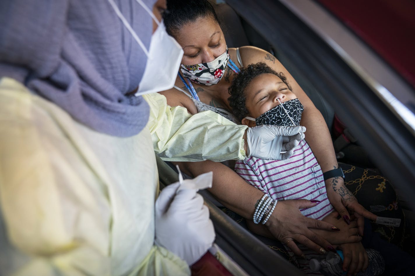 Jessica Steele of St. Paul held her son Little Bear Chatman, Jr., 6, as he was tested at the drive-through COVID-19 testing site at North Memorial Health in Robbinsdale on Nov. 6. The facility tested a total of 744 people that day.