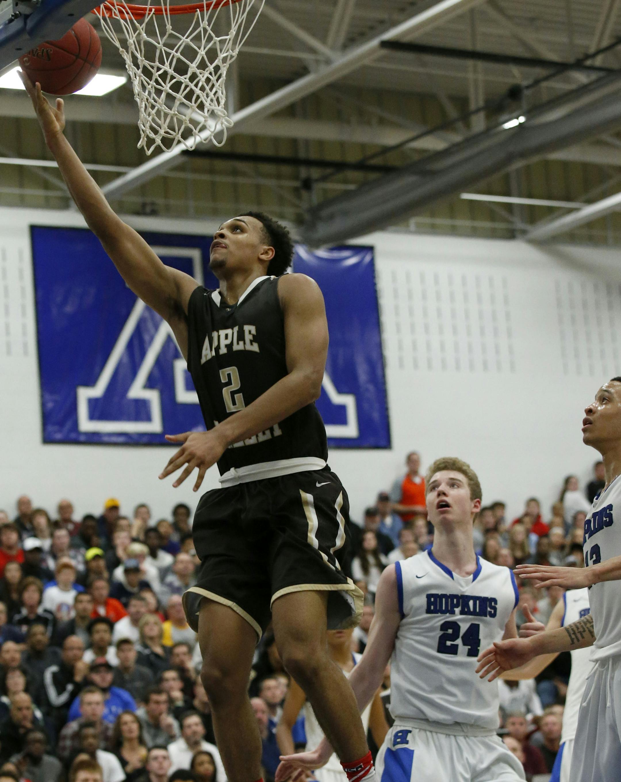 Apple Valley guard Gary Trent Jr. (2) drives to the basket past Hopkins guard Amir Coffey, right, and Hopkins center Eric Davis (24) during the second half in Minnetonka, Saturday, Dec. 12, 2015. Hopkins defeated Apple Valley 89-81. ( Photo/Ann Heisenfelt) ORG XMIT: 596959 prep121315 12