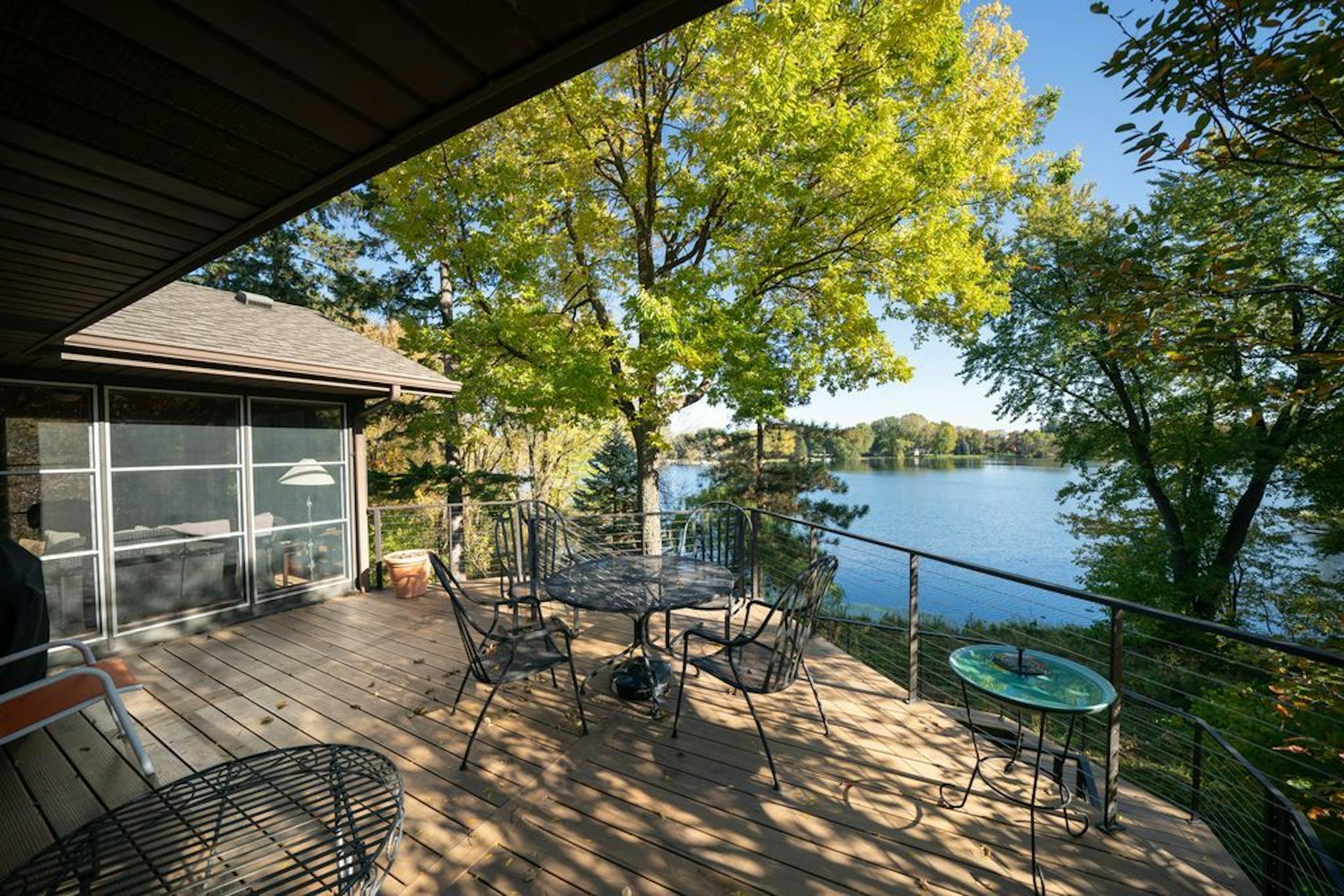 The redesigned home makes the most of its setting on a small lake.