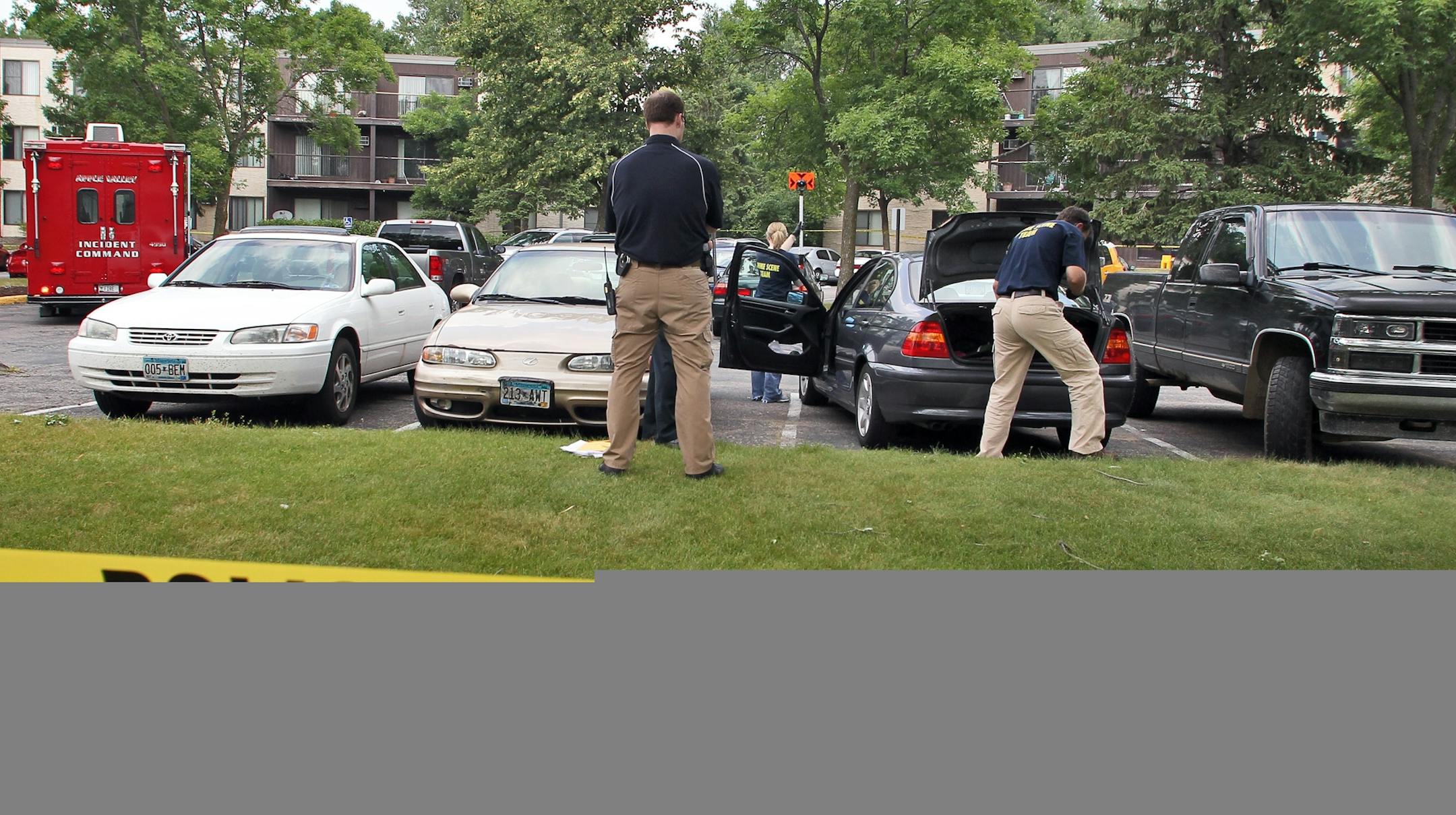 Homicide crime scene in parking lot of South Cedar Knoll apartments at 12790 Germane Ave. in Apple Valley. Investigators work around car of interest in parking lot. (MARLIN LEVISON/STARTRIBUNE(mlevison@startribune.com