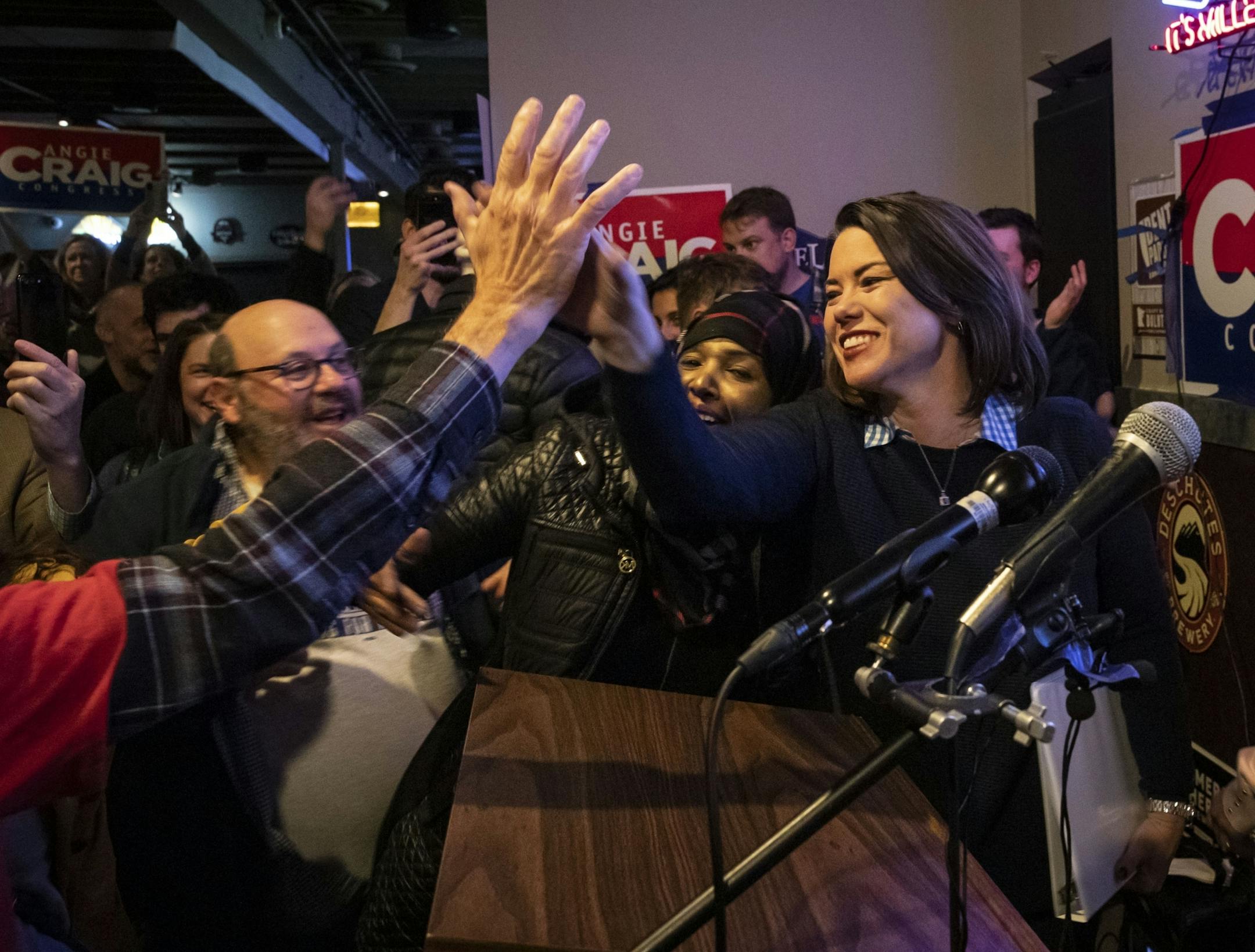 Angie Craig high fived supporters after winning the 2nd congressional district on Tuesday, November 6, 2018, at an election party for her at the Lone Oak Grill in Eagan, Minn.