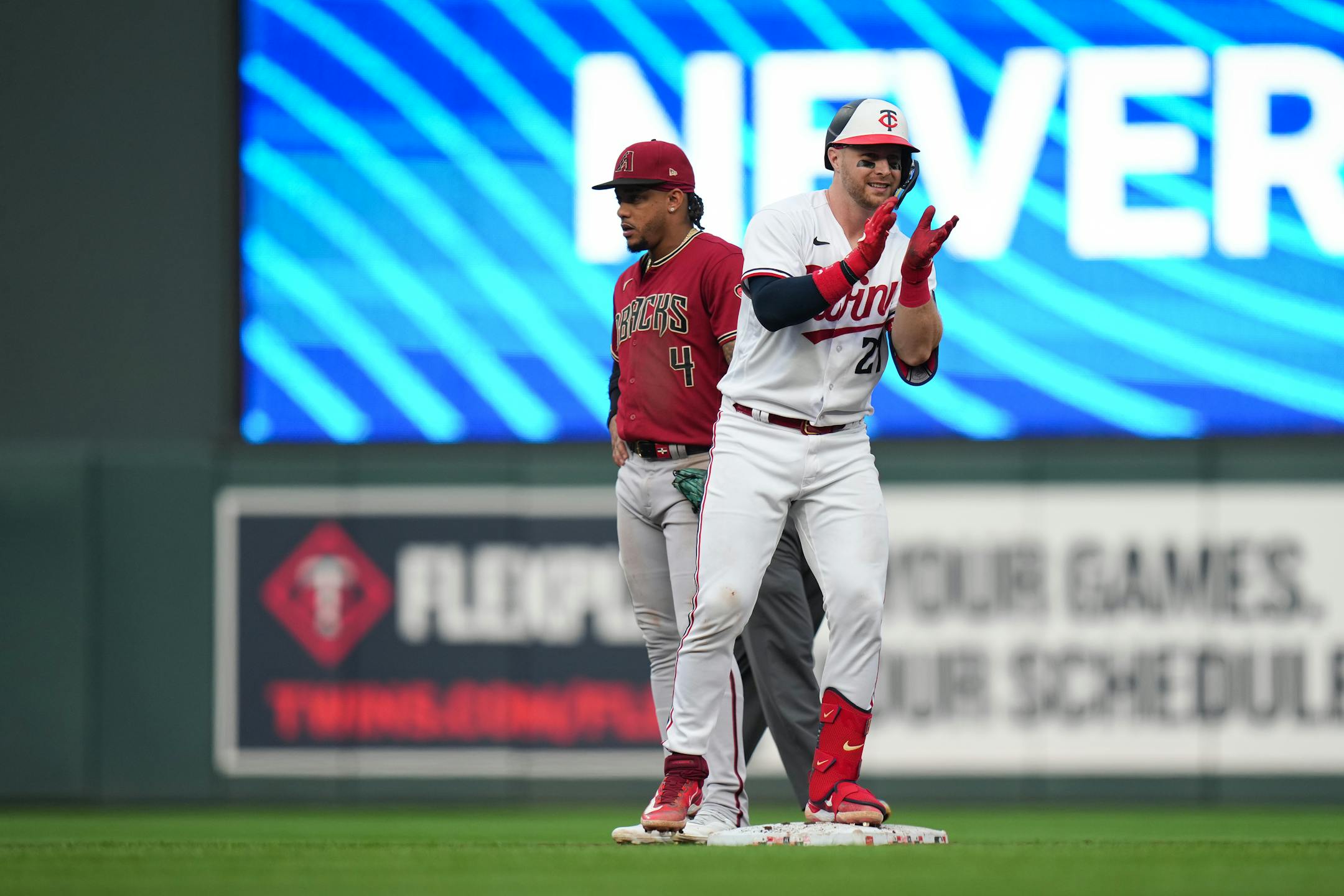 Minnesota Twins catcher Ryan Jeffers (27) cheers with his teammates after hitting a double in the third inning against the Arizona Diamondbacks.