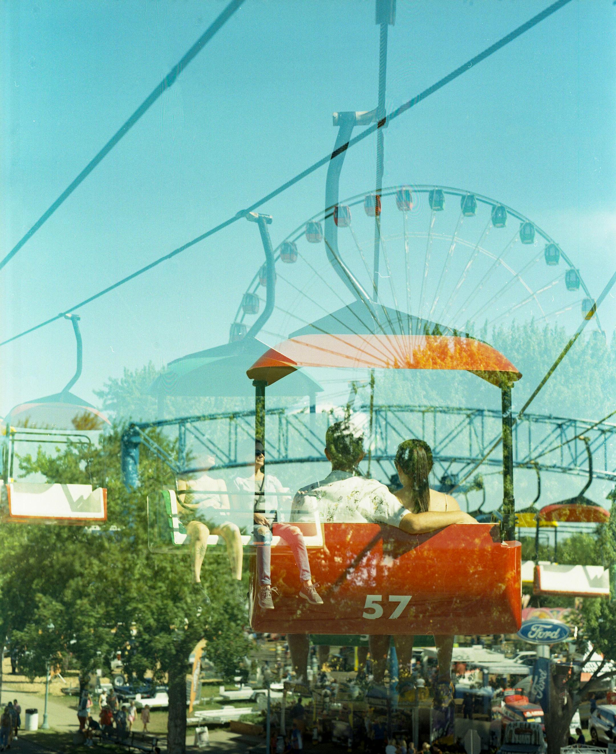 The Sky Glider is double exposed with the Giant Wheel Tuesday, August 30, 2022 at the Minnesota State Fair in Falcon Heights, Minn.    ]