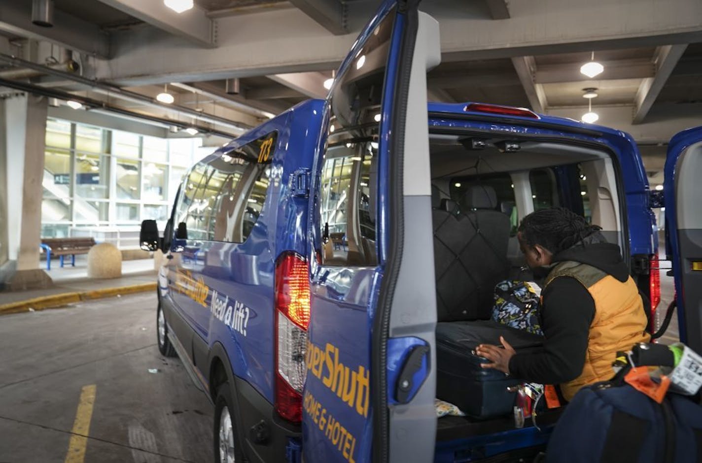 Isaac Harris, of Inver Grove Heights, packed up his SuperShuttle van trunk with a rider's luggage at the Minneapolis-St. Paul International Airport in Minneapolis, Minn., on Thursday, November 14, 2019. Harris said he has been a contract driver for SuperShuttle for over a year and he owns his own van.