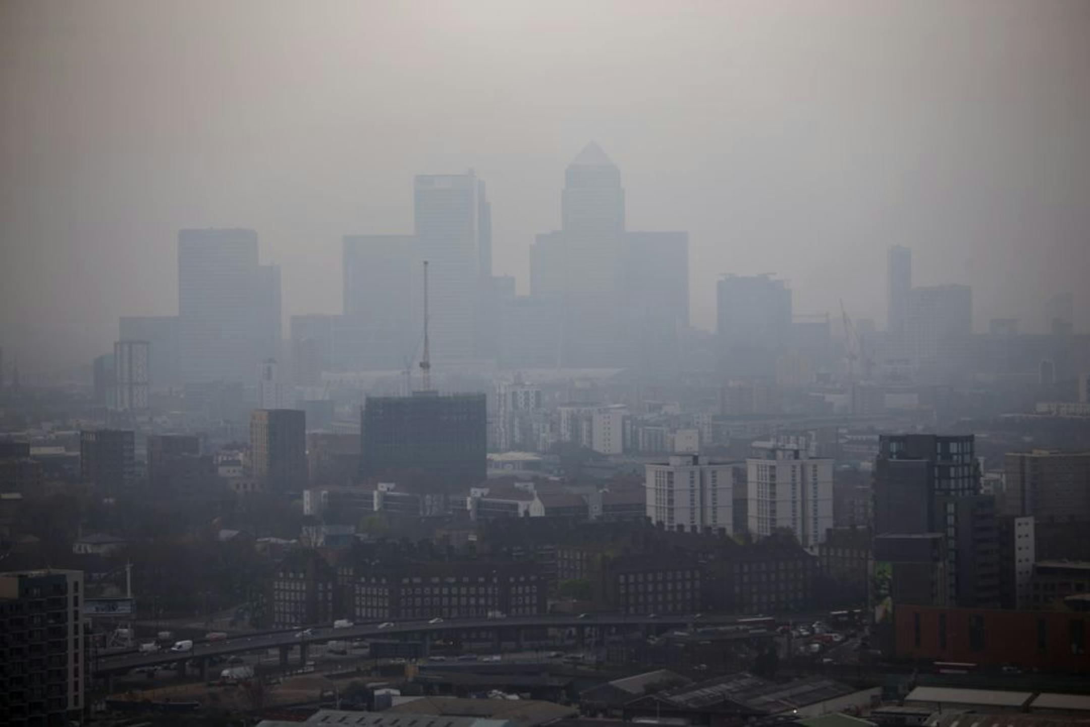 The skyscrapers of the Canary Wharf business district in London are shrouded in smog Wednesday, April 2, 2014.