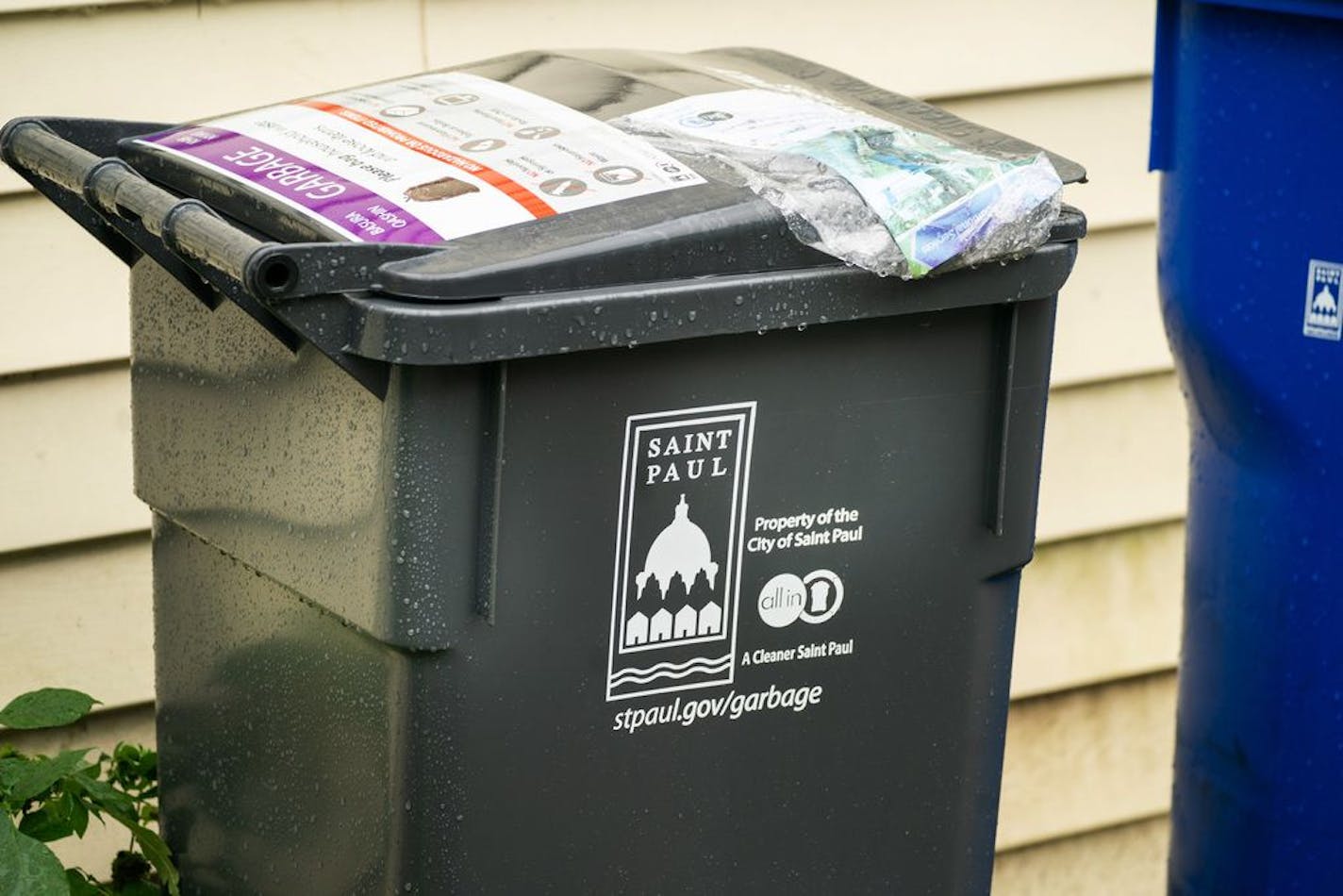 A new Saint Paul garbage can. Waste Management worker Daniel Westerhaus collected trash from the alleys of the Snelling Hamline neighborhood of St Paul's yellow zone on the first day of organized trash collection.