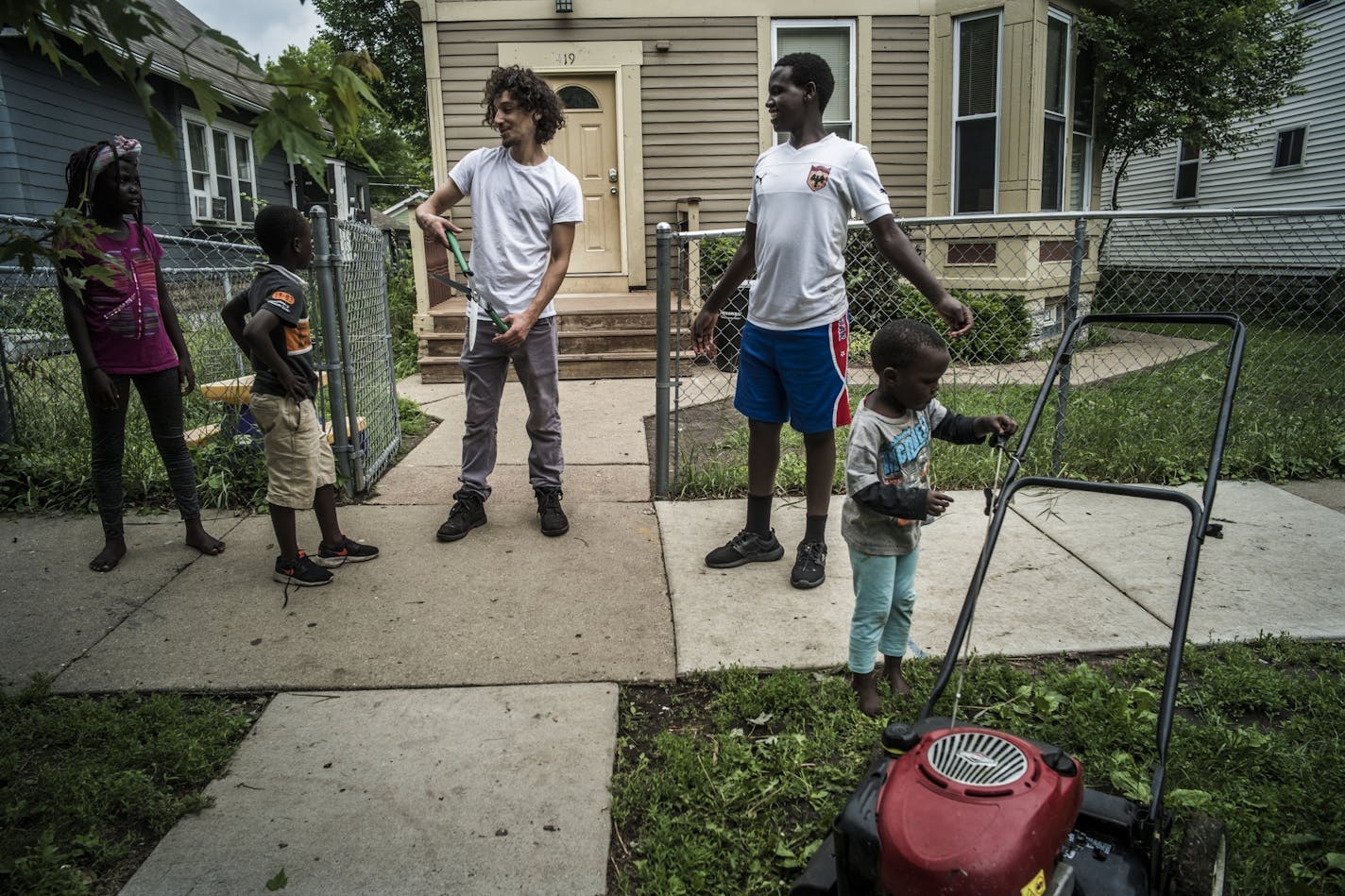 Trucker and triplex owner Moises Romo got some help from the children of his Kenyan tenants while doing yard work in the Frogtown neighborhood of St. Paul in 2018.