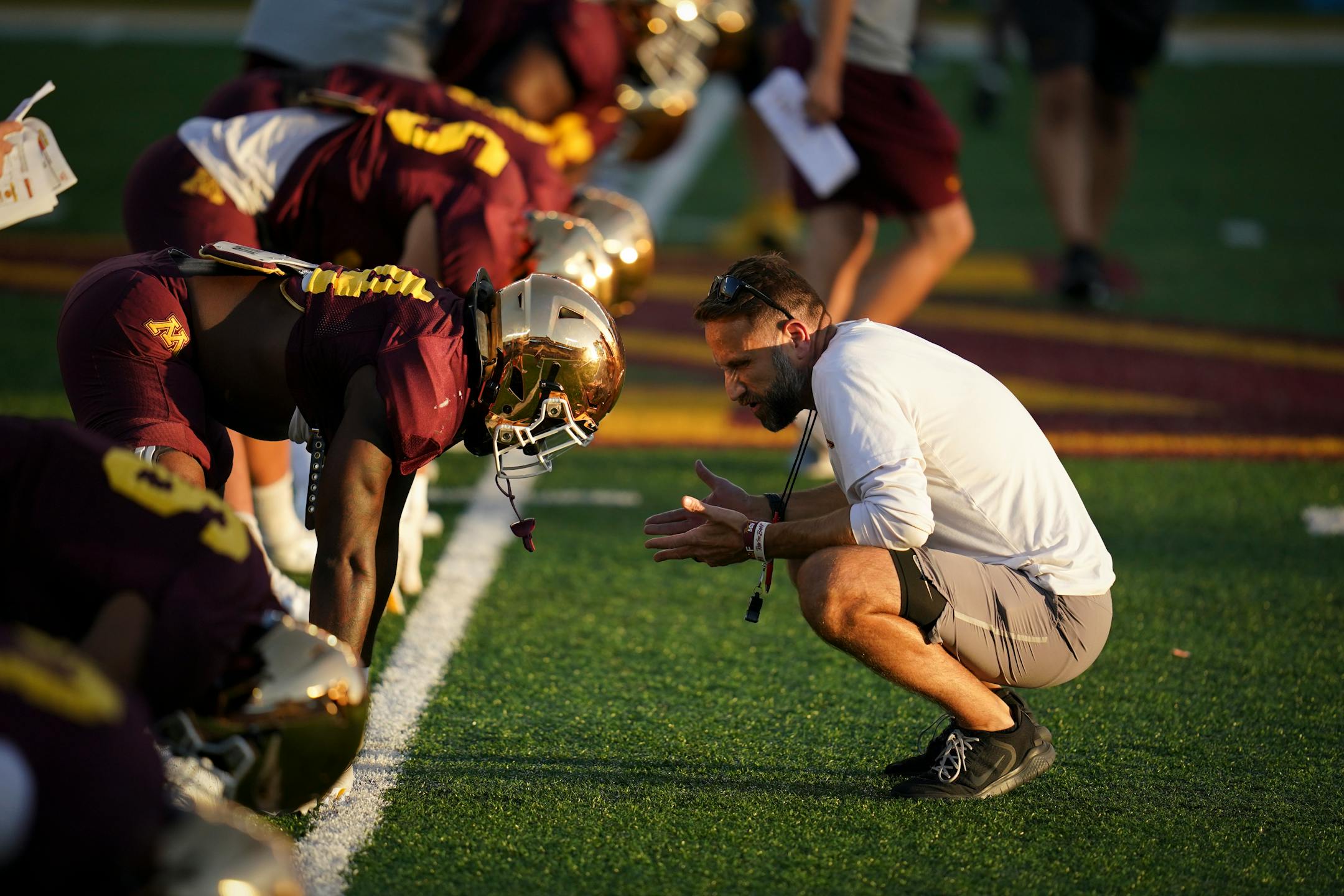 Defensive coordinator Joe Rossi spoke with linebacker Braelen Oliver (14) during Gophers practice at Huntington Bank Stadium at the University of Minnesota in Minneapolis, Minn., on Thursday, August 12, 2021.