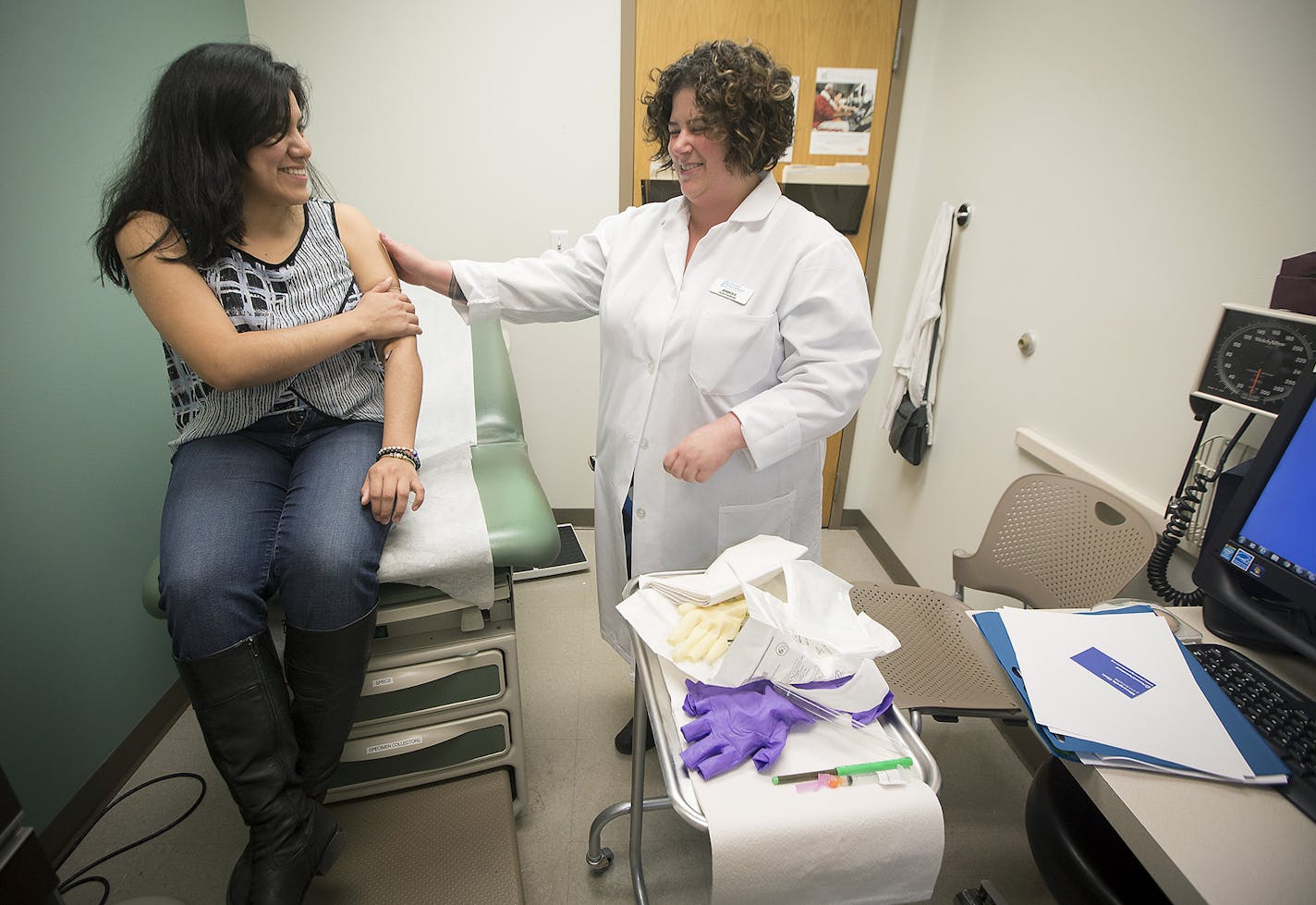 Nurse practitioner Jessica Zaldivar, right, injected a Nexplanon birth control implant into the arm of patient Andrea Castillo, 22, at Planned Parenthood in Minneapolis.