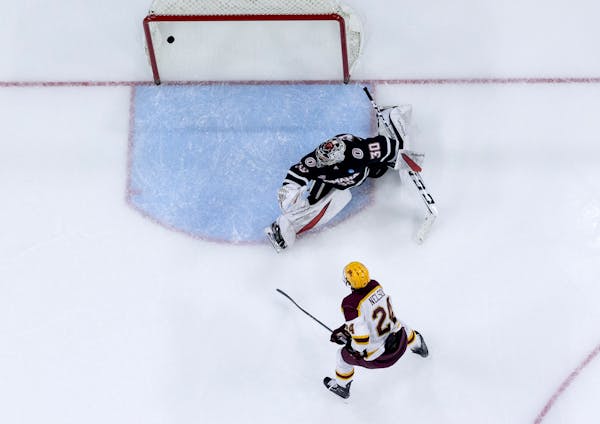 Jaxon Nelson (24) steered the puck past Nebraska Omaha goalie Simon Latkoczy for the winning goal, and his second of the third period, in the Gophers'