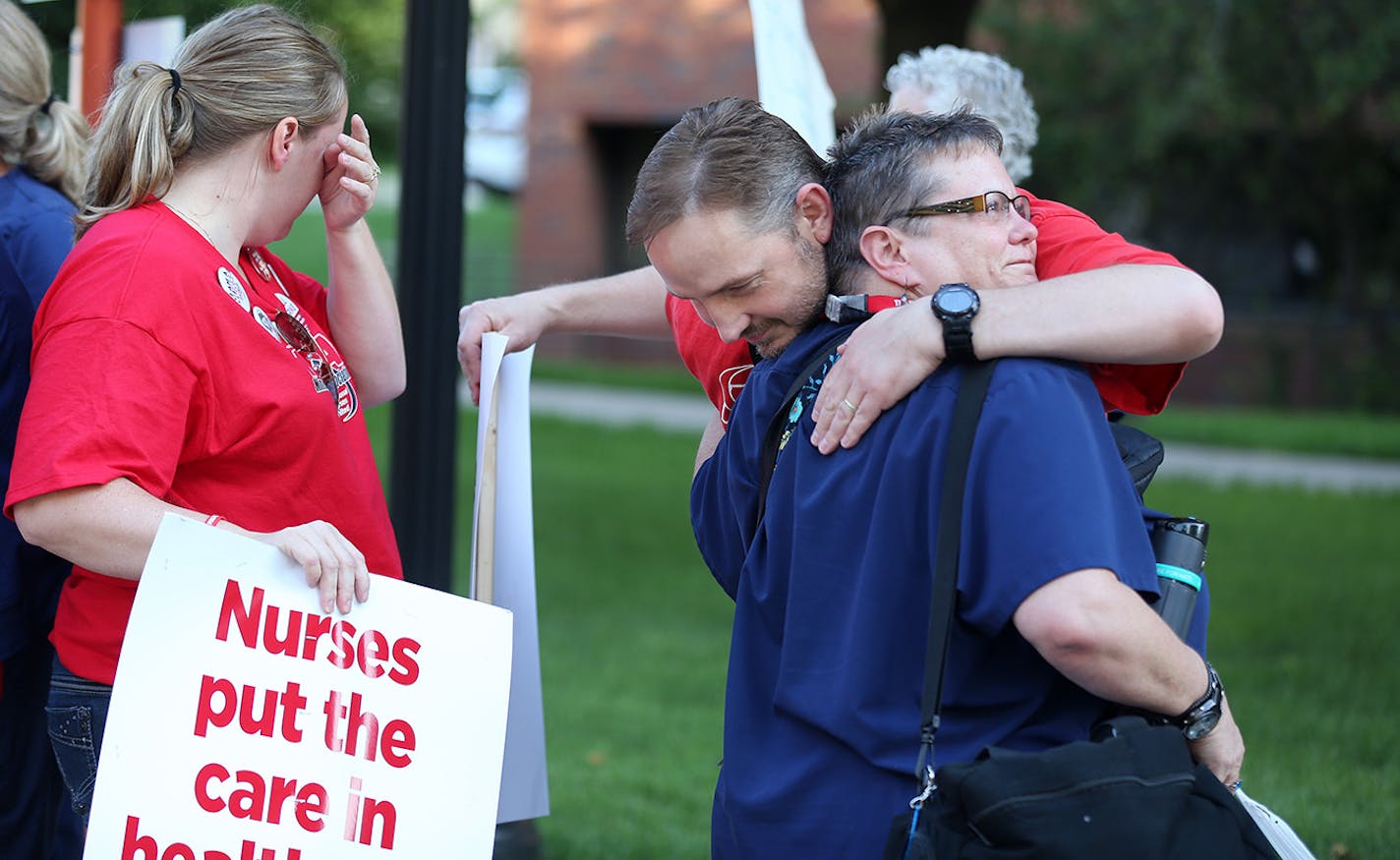 Nurse Donna VanStralen right, was hugged by a co-worker as she walked out of the Abbot Northwestern Hospital at the end of her shift at 7am, to join other nurse on the picket line Sunday June 19, 2016 in Minneapolis, MN.