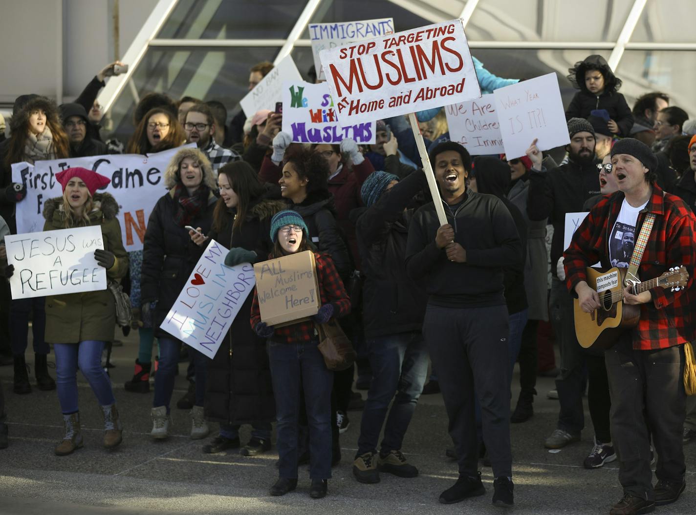 Demonstrators gathered Sunday across the street from Terminal 1 at Minneapolis-St. Paul Airport.