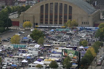 Vikings tailgaters set up camp in lots near the armory in downtown Minneapolis.