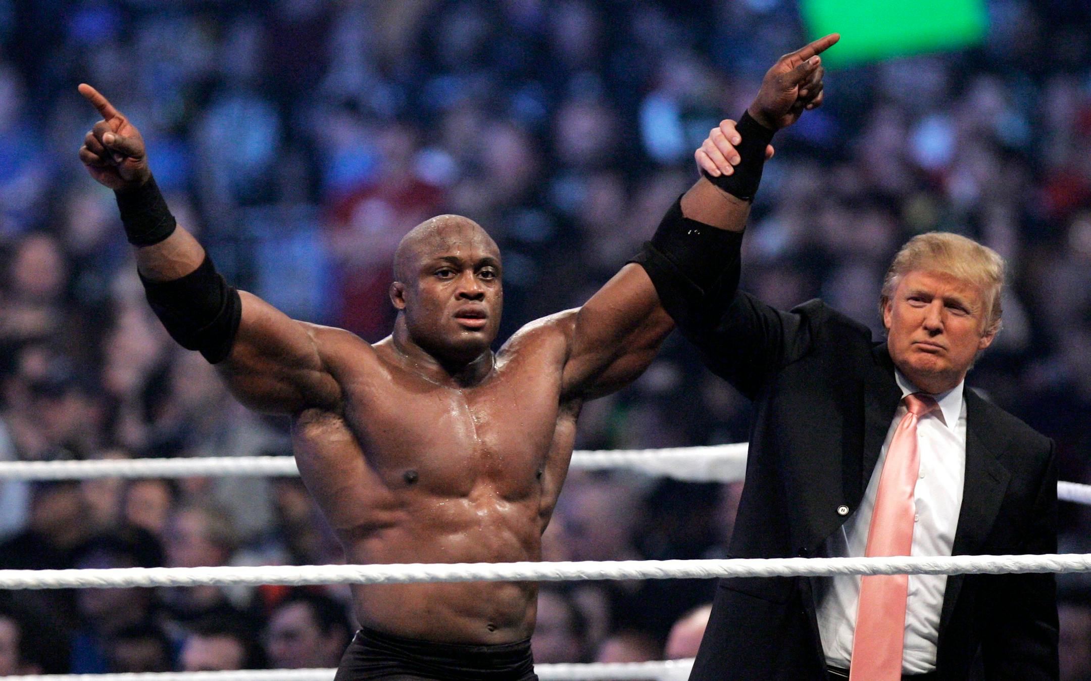 FILE - In this Sunday, April 1, 2007, file photo, Donald Trump raises the arm of wrestler Bobby Lashley after he defeated Umaga at Wrestlemania 23 at Ford Field in Detroit. Trump body-slammed and then shaved the head of WWE boss Vince McMahon after what was known as the �Battle of the Billionaires." Wrestling aficionados say the president has, consciously or not, long borrowed the time-tested tactics of the game to cultivate the ultimate antihero character, a figure who wins at all costs, incite