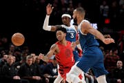 Trail Blazers guard Anfernee Simons passed between Wolves forward Jaden McDaniels, rear, and center Rudy Gobert in a Feb. 13 game in Portland. The Wol