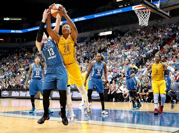 Lindsay Whalen (13) and Tamika Catchings (24) fought for a loose ball in the third quarter.