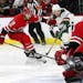 Minnesota Wild's Charlie Coyle (3) breaks away from Carolina Hurricanes' Jaccob Slavin (74) to shoot the puck at goalie Scott Darling (33) during the 