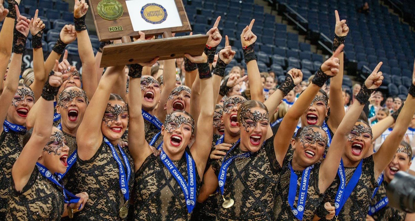 Eastview high kick dance team members celebrate after receiving their championship trophy on Feb. 15, 2020 at Target Center. (Photo by Pat Campbell)