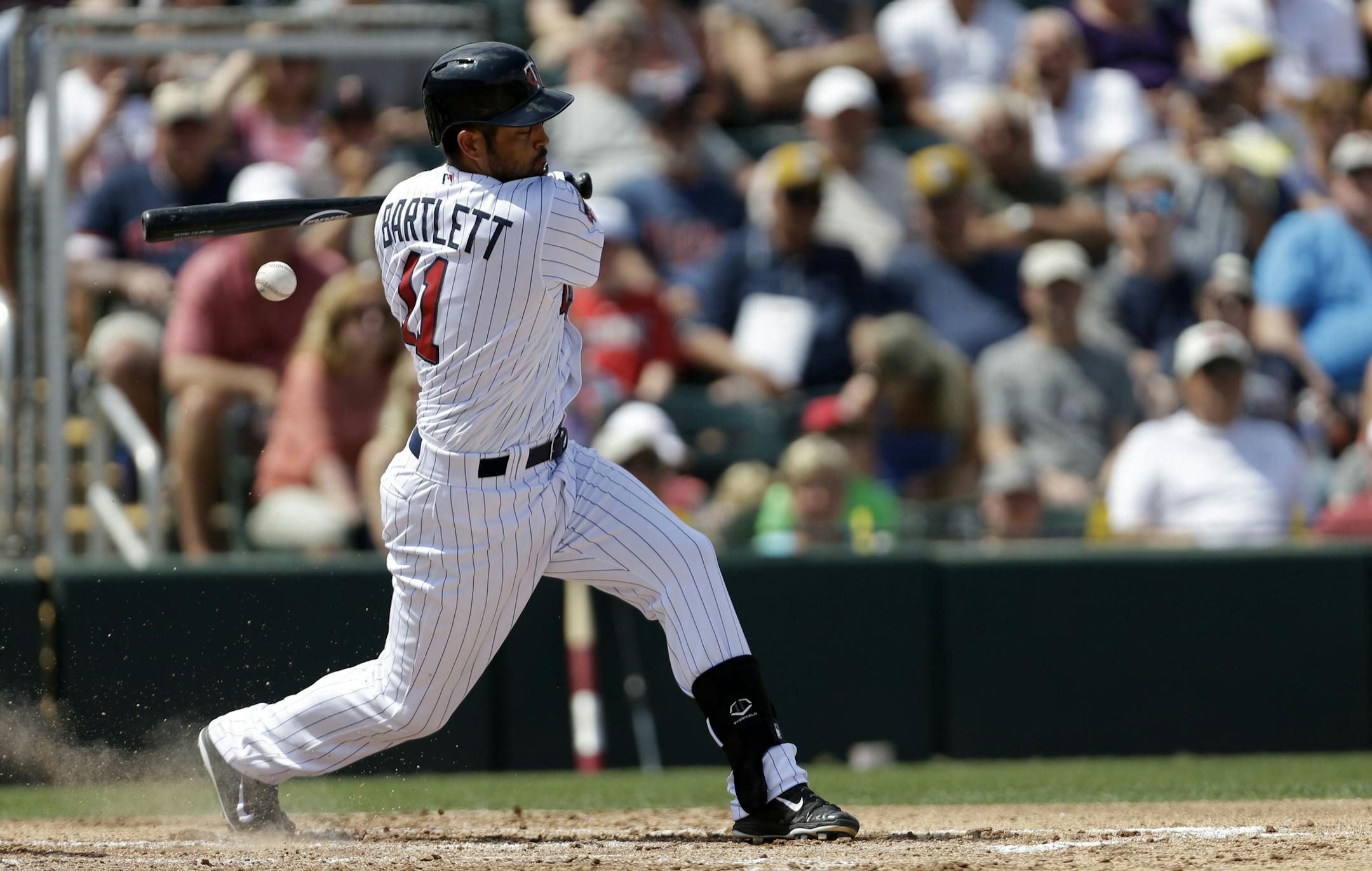 Minnesota Twins shortstop Jason Bartlett (11) hits a foul ball during an exhibition baseball game in Fort Myers, Fla., Wednesday, March 12, 2014. (AP Photo/Gerald Herbert)