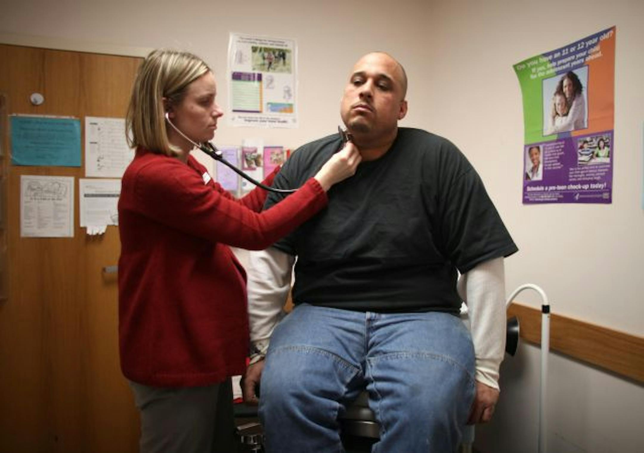 Dr. Jill Miedema examined Adam Barnes, 37, of Minneapolis on Friday afternoon at the Fremont Clinic. He made an appointment because he has high blood pressure and hasn't been taking medicine for it because he doesn't have health insurance.