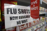 FILE - In this Sept. 16, 2014 file photo, a sign telling customers that they can get a flu shot in a Walgreen store is seen in Indianapolis. Kids may 