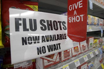 FILE - In this Sept. 16, 2014 file photo, a sign telling customers that they can get a flu shot in a Walgreen store is seen in Indianapolis. Kids may 