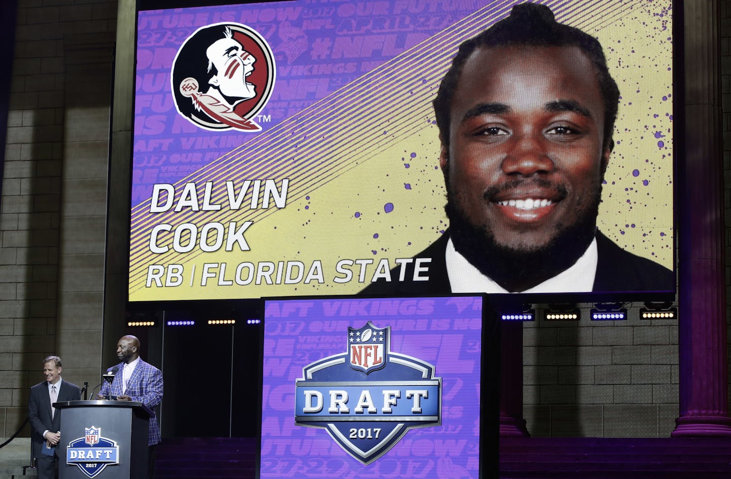 Former Minnesota Vikings player John Randle, right, announces Florida State's Dalvin Cook as the Vikings selection in the second round of the 2017 NFL football draft as NFL commissioner Roger Goodell stands by, Friday, April 28, 2017, in Philadelphia. (AP Photo/Matt Rourke)