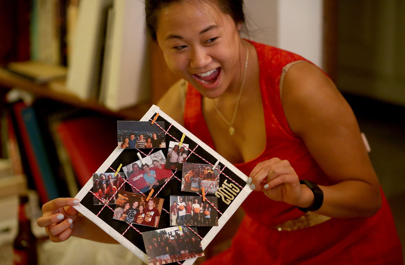 Chloe Edwards showed off her newly decorated graduation cap with pictures of her family. ] (KYNDELL HARKNESS/STAR TRIBUNE) kyndell.harkness@startribune.com A party at Hanna DeGroot's apartment, where she and some gal pals will be decorating their graduation caps in Minneapolis Min., Friday, May 8, 2015.