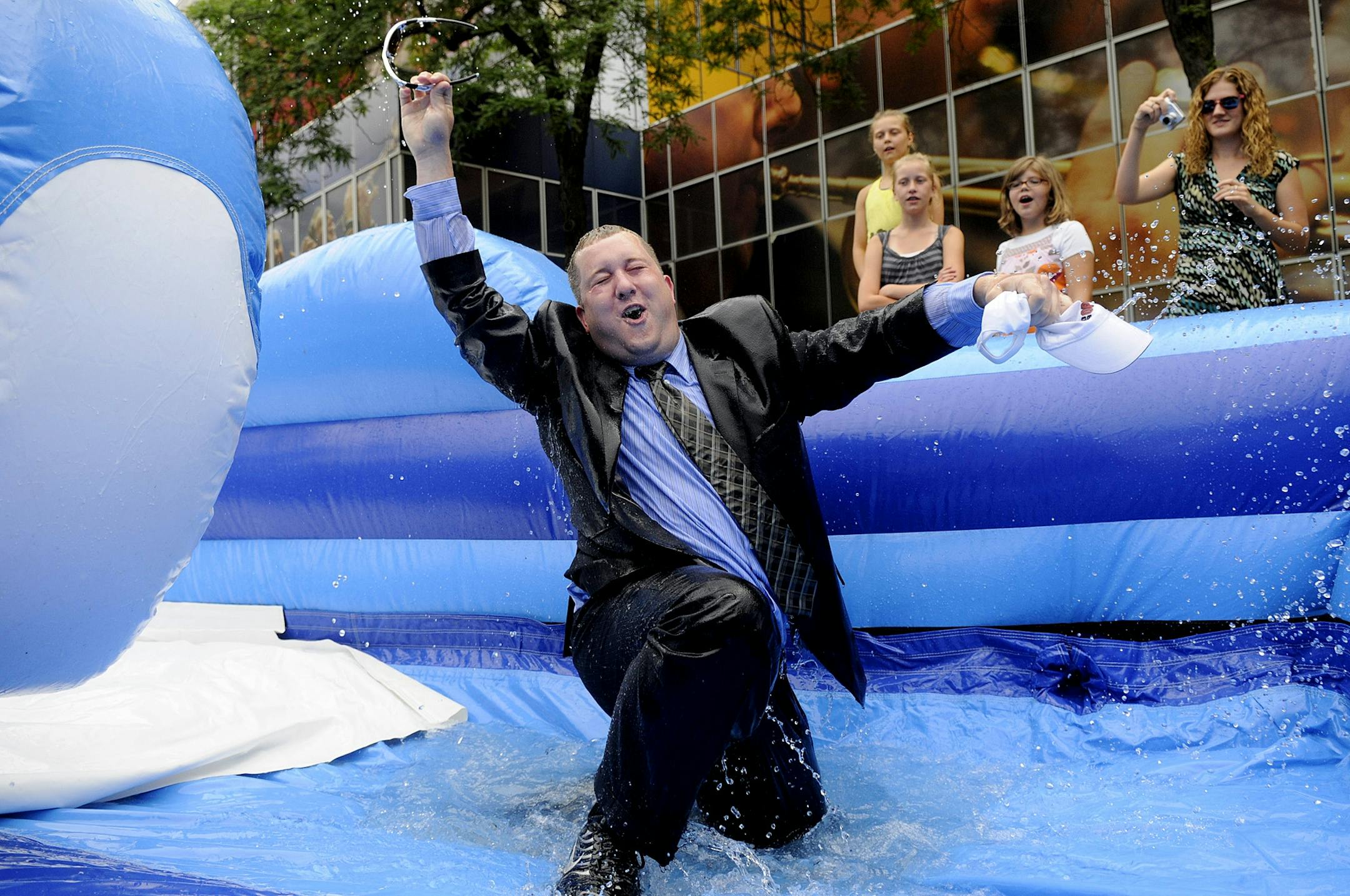 Tunheim Partners, public relations employee Bill Brozak from St. Paul, plunged down a two story water slide in a full suit at Peavey Plaza. The Minneapolis Aquatennial, kicked-off the festival countdown to the Best Days of Summer.