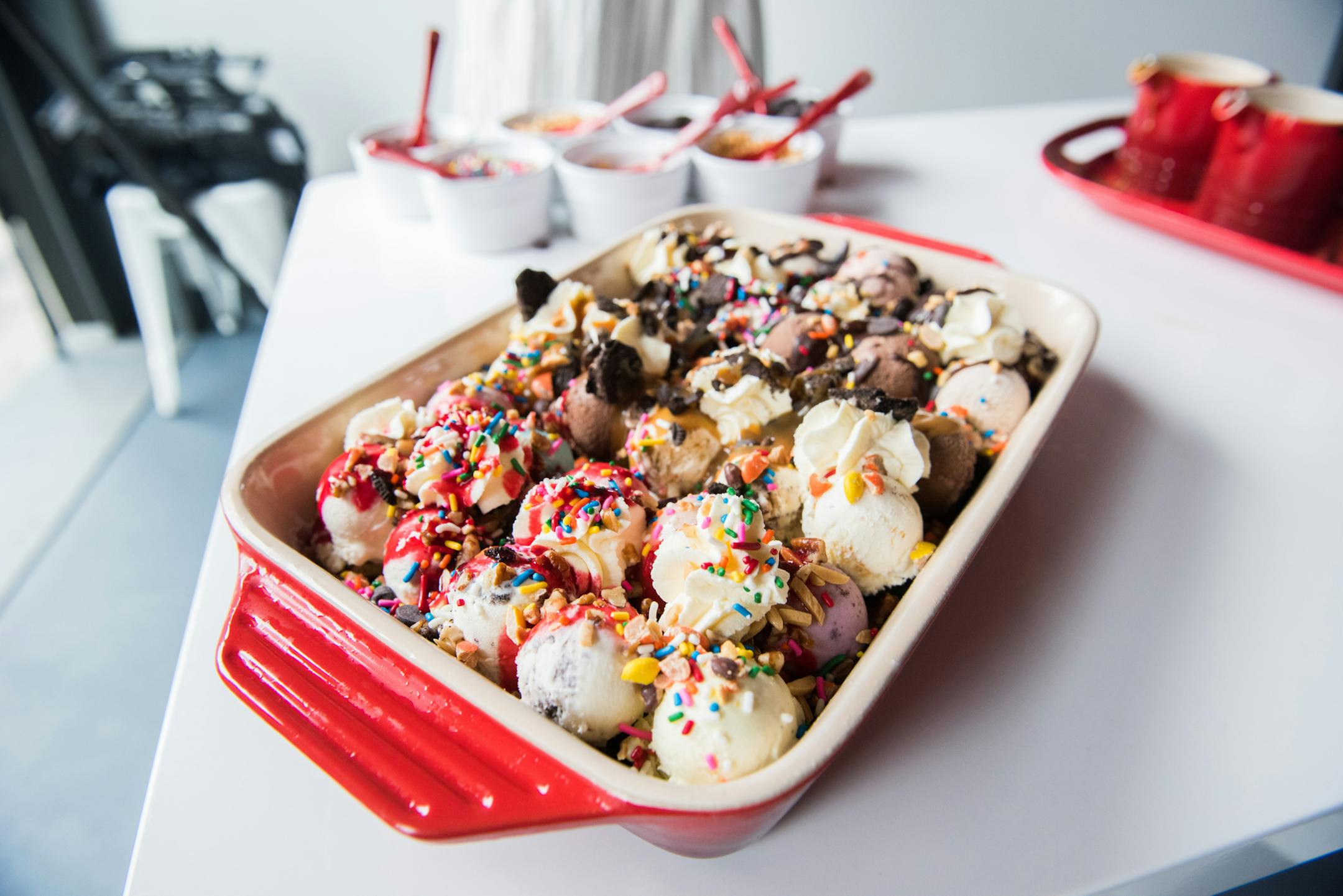 Those who choose to partake in the Hot Dish can add three sauces, seven candy and nut toppings and homemade whipped cream. ] MARK VANCLEAVE ï mark.vancleave@startribune.com * The Hot Dish at Izzy's Ice Cream features a red Le Creuset dish filled with crushed up cones, brownies and a dainty Izzy scoop of each of the 32 flavors in the cabinet. Photographed Thursday, Aug. 3, 2017.