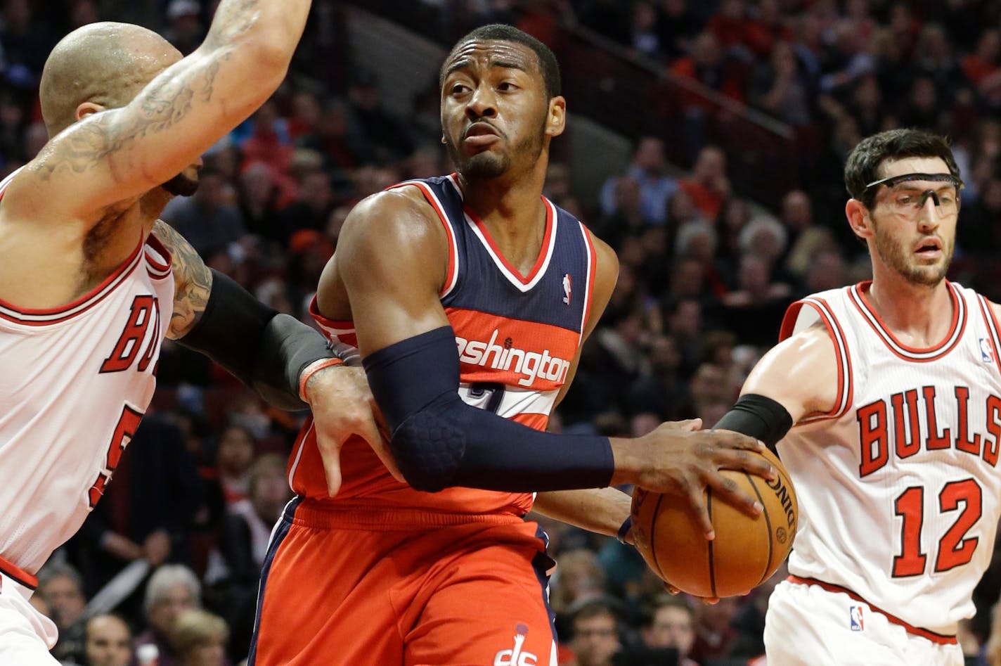 Washington Wizards guard John Wall, center, agreed to a five-year contract extension worth about $80 million.