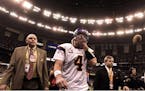 Brett Favre, injured and battered, walked off the field.