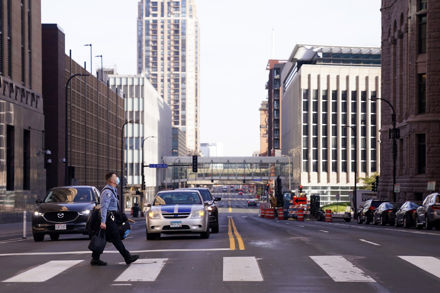 A Minneapolis Police officer walked to City Hall with a bag of riot gear while news circulated that Joe Biden was pulling ahead of President Donald Trump on Nov. 6.