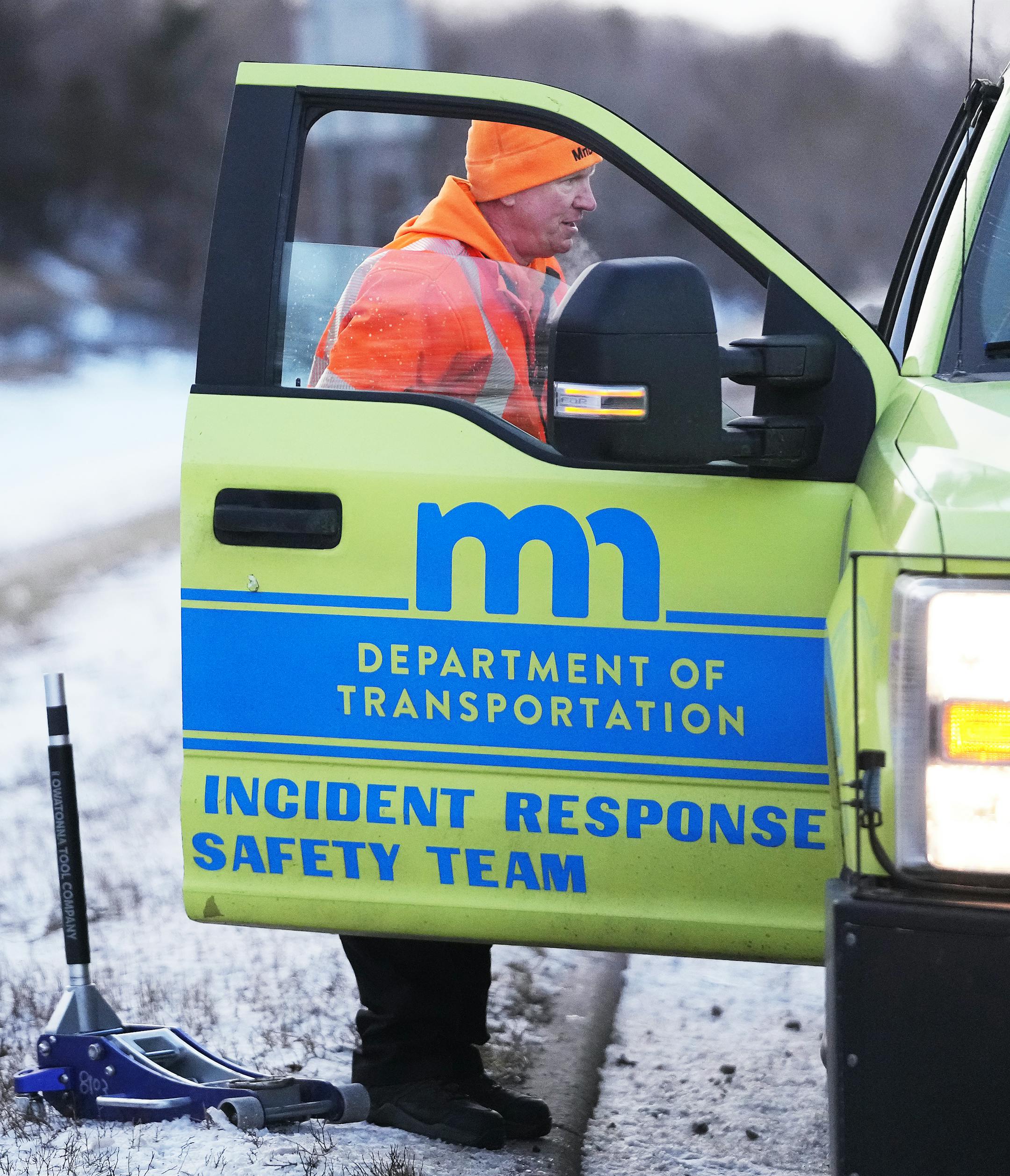 Mike Ahlman, a driver for MnDOT's Freeway Incident Response Safety Team, put away his hydraulic lift after changing a flat tire for a stranded motorist along Highway 100.