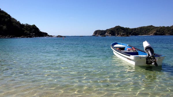 935: A boat in a quiet bay, where snorkelers visit, in Huatulco, Mexico. ] PAM LOUWAGIE