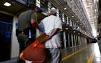 A death row inmate is escorted back to his East Block cell after spending time in the yard at San Quentin State Prison, San Quentin, Calif., on August