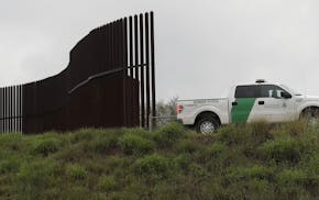 FILE - In this Nov. 13, 2016 file photo, a U.S. Customs and Border Patrol agent passes along a section of border wall in Hidalgo, Texas. The GOP-contr