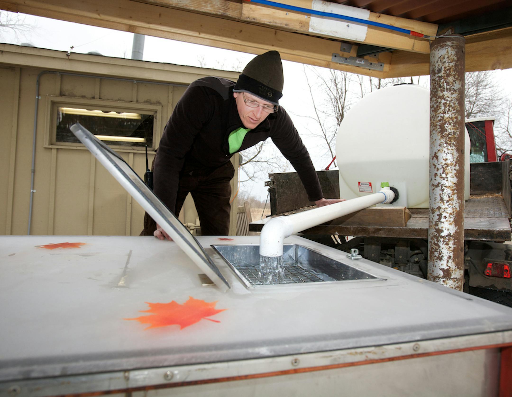 Richard DeVries, natural resources manager at the Minnesota Landscape Arboretum, watched collected sap go into an evaporator.