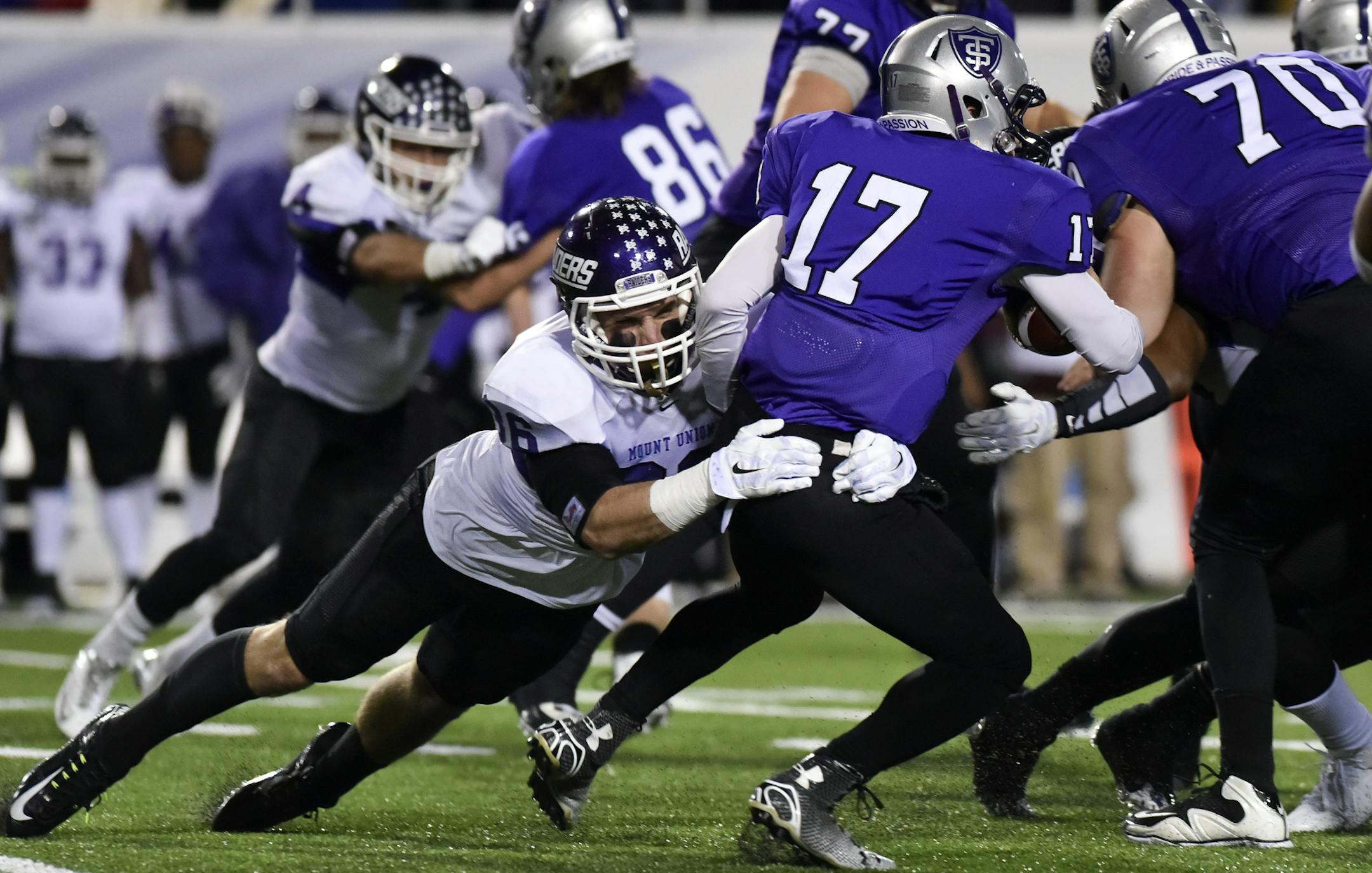 St. Thomas quarterback John Gould (17) is sacked by Mount Union defensive lineman Mike Furda (86) in the second half of the NCAA Division III football championship game in Salem, Va., Friday, Dec. 18, 2015. (AP Photo/Michael Shroyer)