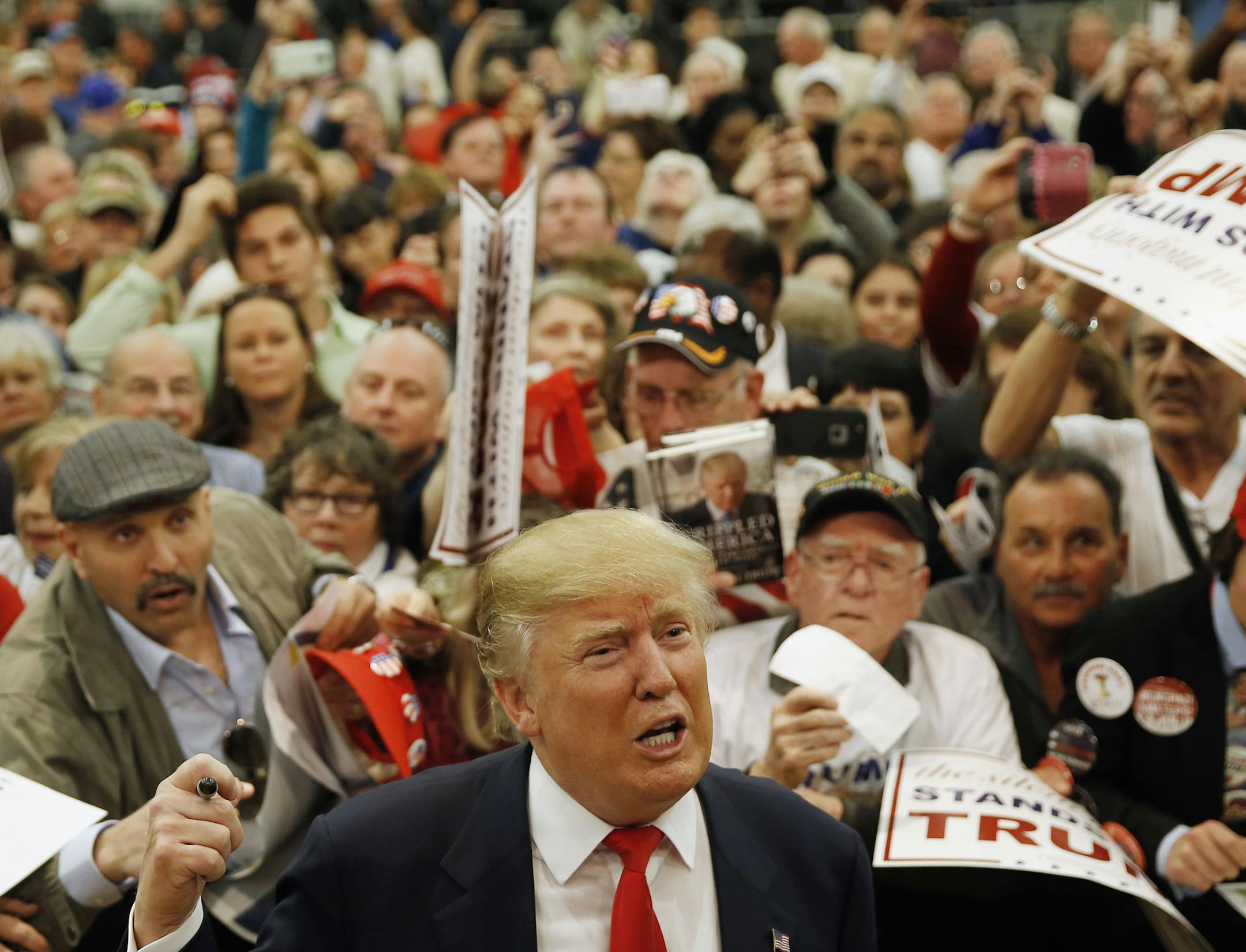 Republican presidential candidate Donald Trump speaks speaks with members of the media as he meets with attendees during a campaign stop, Friday, Feb. 19, 2016, in Myrtle Beach, S.C. (AP Photo/Matt Rourke)