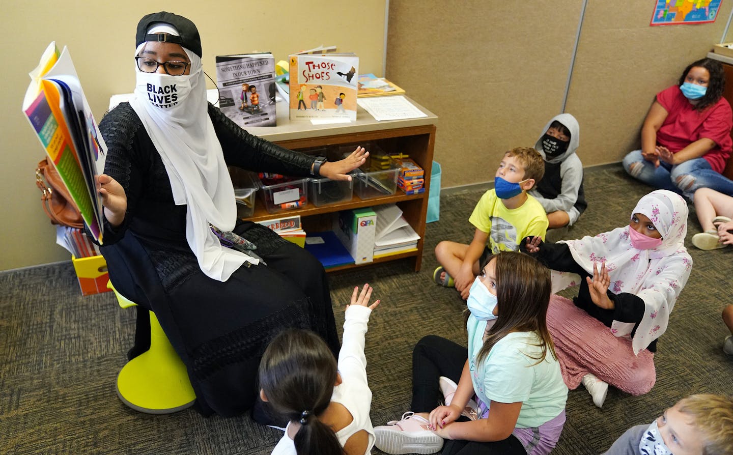 Qorsho Hassan demonstrated to her students how to push through something as she read to them Friday morning at Echo Park Elementary School. ] ANTHONY SOUFFLE • anthony.souffle@startribune.com Qorsho Hassan taught her fourth grade class Friday, Sept. 25, 2020 at Echo Park Elementary School in Burnsville, Minn. Hassan is the state's current teacher of the year and is all on board with boosting the ranks of teachers of color, but she's putting a twist on the cause by saying too many like her are vu