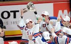 United States forward Luke Kunin (9) lifts the trophy as he and his teammates celebrate their victory over Canada in the final of the world junior cha
