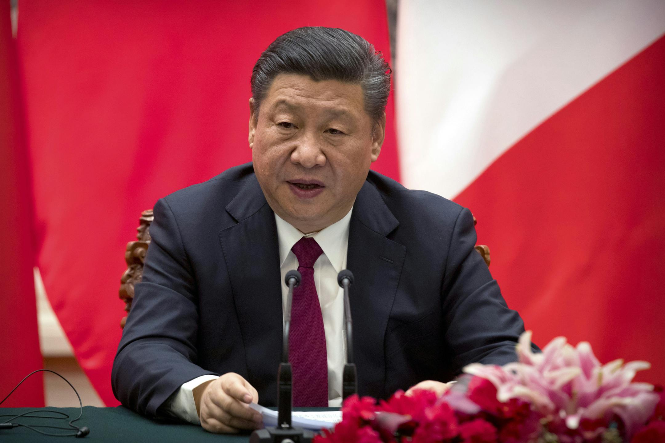 FILE In this Tuesday, Jan. 9, 2018, file photo, Chinese President Xi Jinping speaks during a joint press briefing with French President Emmanuel Macron, at the Great Hall of the People in Beijing.In a rare public expression of dissent in China, a well-known political commentator and a prominent businesswoman penned open letters urging lawmakers to reject a plan that would allow President Xi Jinping to rule indefinitely. (AP Photo/Mark Schiefelbein, Pool)