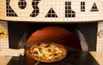 A margherita pizza emerged from the wood fired oven at Rosalia. ] JEFF WHEELER • jeff.wheeler@startribune.com Chef Daniel Dell Prado has opened a pi