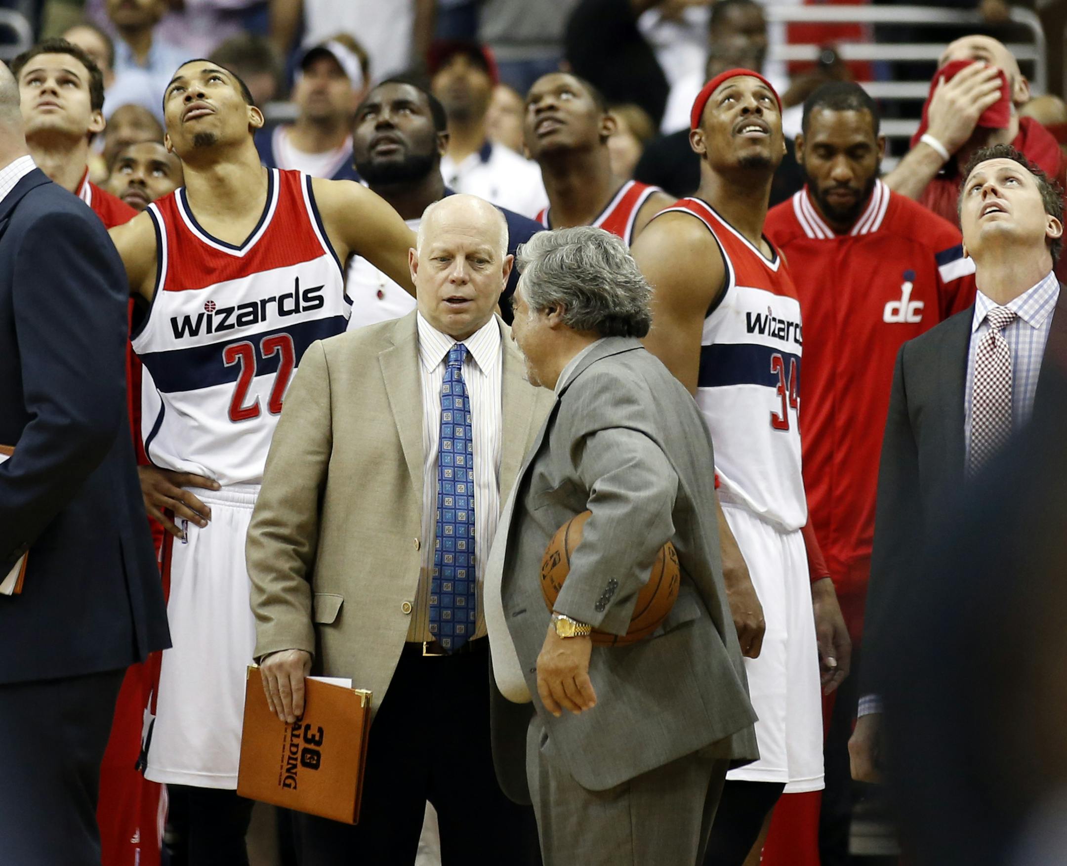 The Washington Wizards, including forward Paul Pierce (34), forward Otto Porter Jr. (22) and guard Garrett Temple (17), watch a replay on the scoreboard as time expires Game 6 of the second round of the NBA basketball playoffs against the Atlanta Hawks, Friday, May 15, 2015, in Washington. The Hawks won 94-91 to advance to the next round. (AP Photo/Alex Brandon)