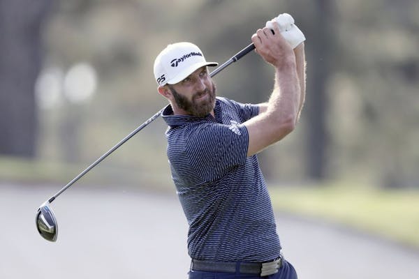 Dustin Johnson tees off on the third hole during the final round of the Masters golf tournament Sunday, Nov. 15, 2020, in Augusta, Ga.
