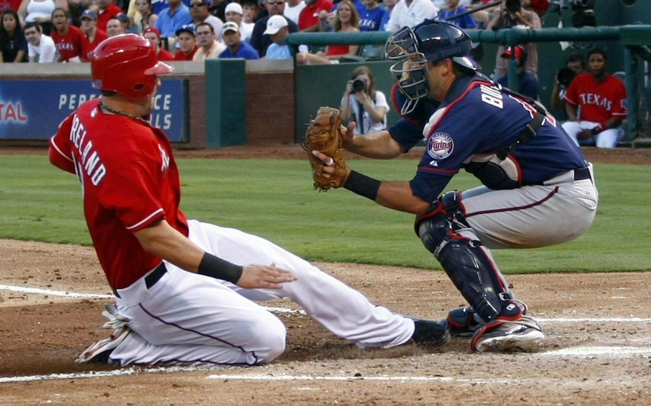 Twins catcher Drew Butera blocked the plate from Texas' Mitch Moreland, applying a tag after a grounder to second. The Twins had three runners thrown out at the plate themselves but still managed to win.