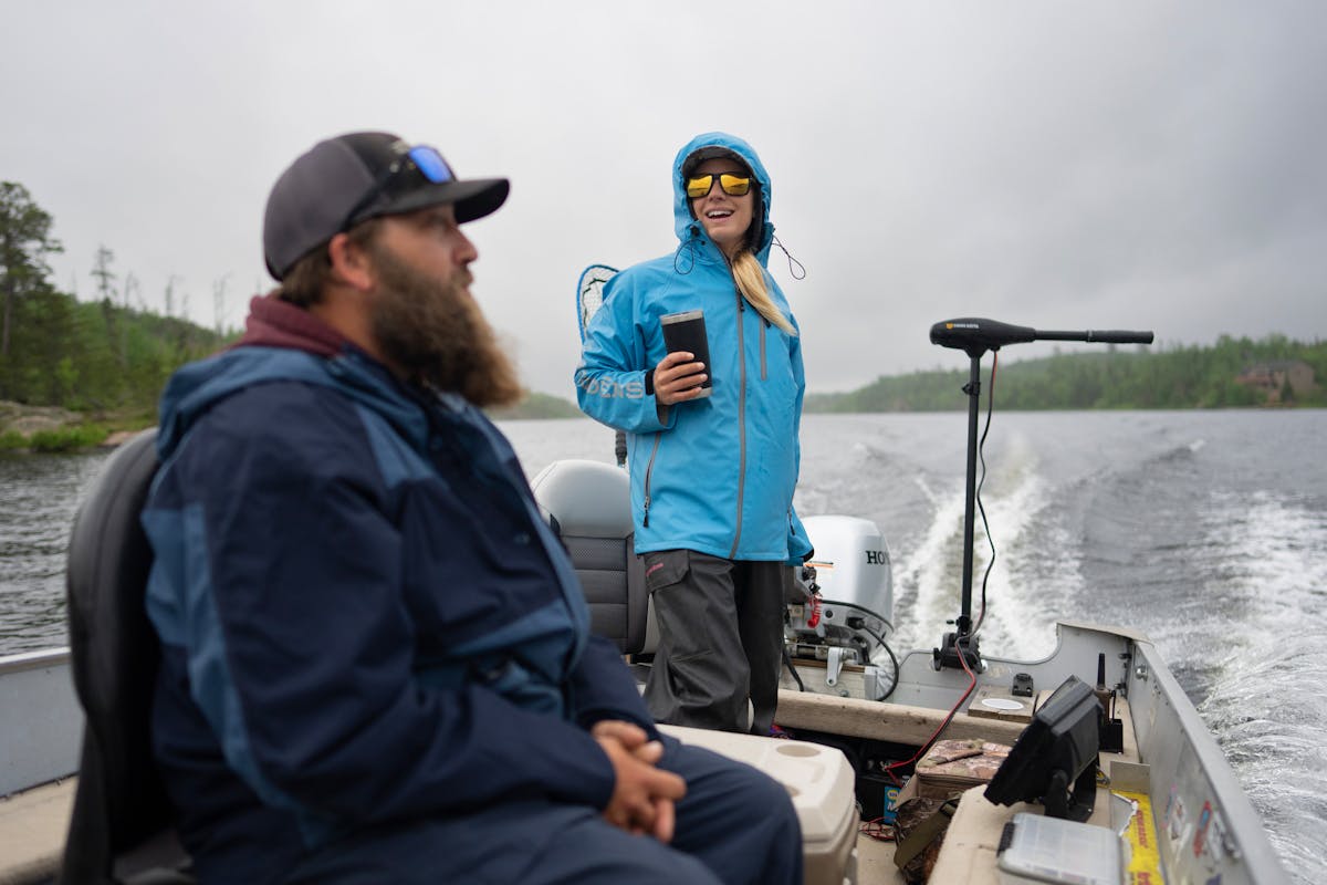 Jessica Berg-Collman pilots her boat to the day’s first fishing spot on Saganaga Lake with client Keith Gausman and his son Kayden, not shown, on bo